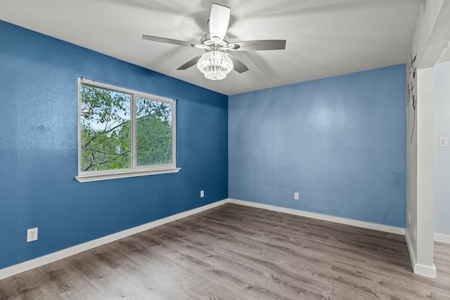 unfurnished room with ceiling fan and hardwood / wood-style flooring