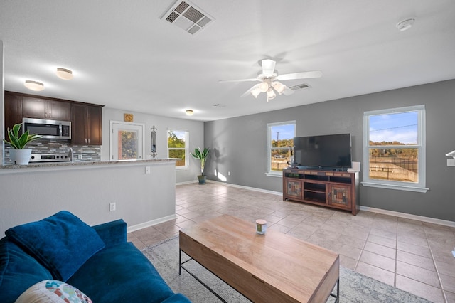 tiled living room featuring ceiling fan