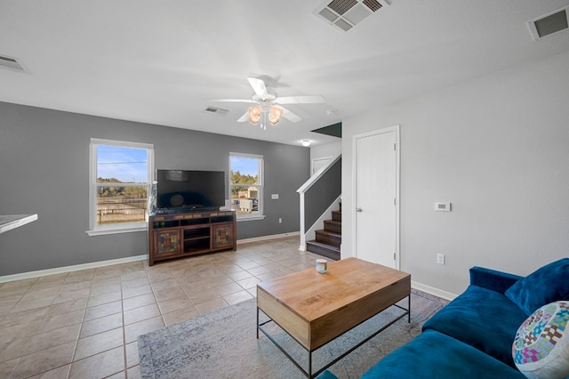 tiled living room featuring ceiling fan