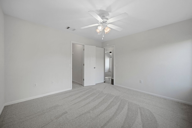 unfurnished room featuring ceiling fan and light carpet