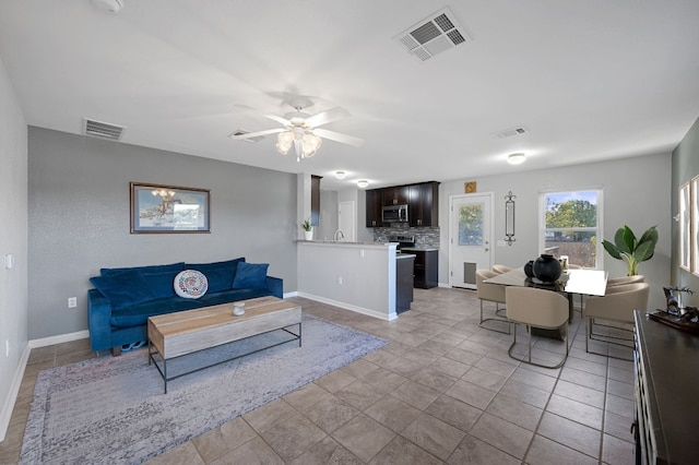 tiled living room with ceiling fan