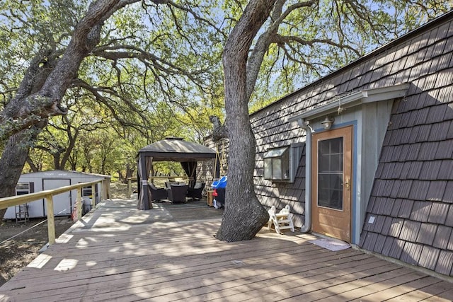 wooden terrace featuring a gazebo