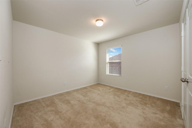 unfurnished room featuring light colored carpet