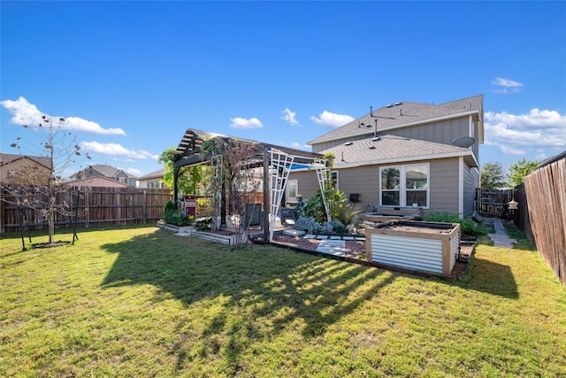 back of house featuring a pergola and a yard