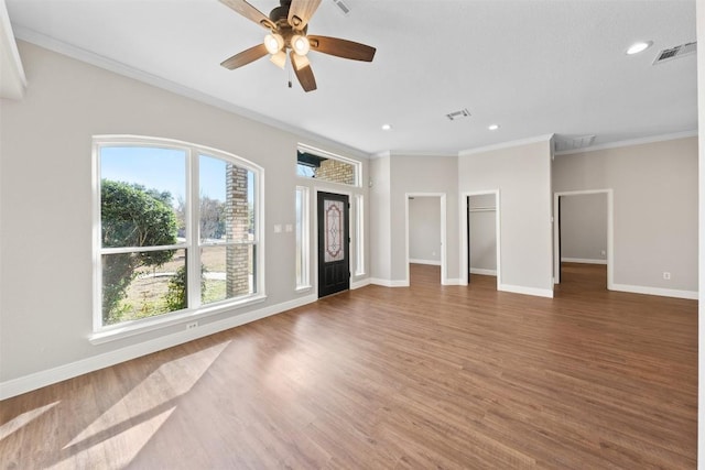 unfurnished living room with crown molding, ceiling fan, and dark hardwood / wood-style floors