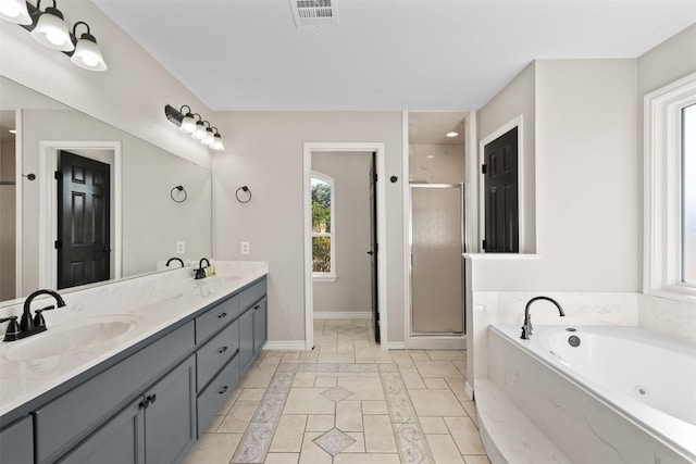 bathroom featuring shower with separate bathtub and vanity