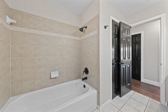 bathroom featuring hardwood / wood-style flooring and tiled shower / bath combo