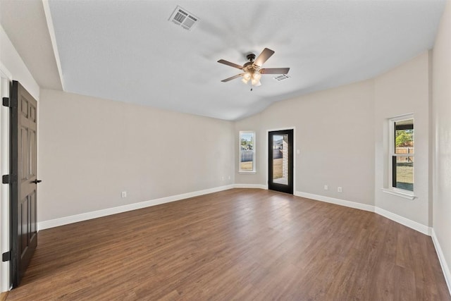 spare room featuring ceiling fan, dark hardwood / wood-style flooring, and vaulted ceiling