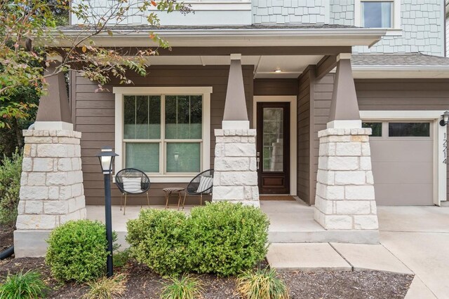 entrance to property with a garage and a porch