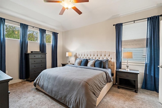 bedroom with ceiling fan, lofted ceiling, and light colored carpet