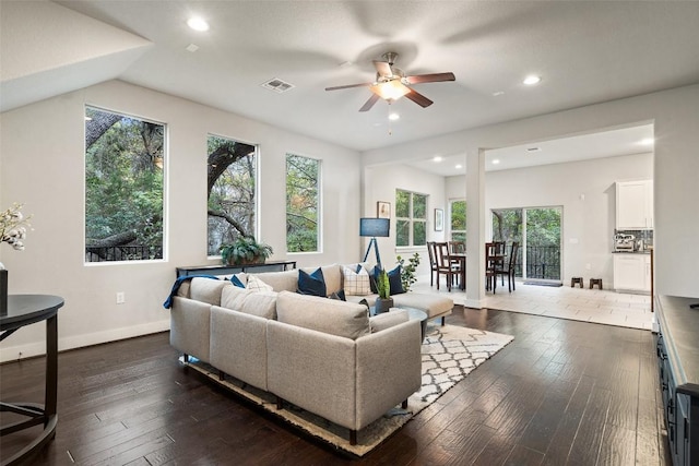 living room featuring dark wood-type flooring, lofted ceiling, a healthy amount of sunlight, and ceiling fan