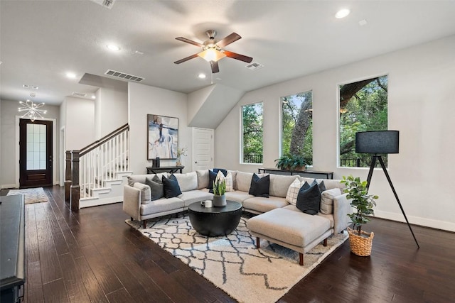 living area featuring stairs, dark wood-style flooring, and visible vents