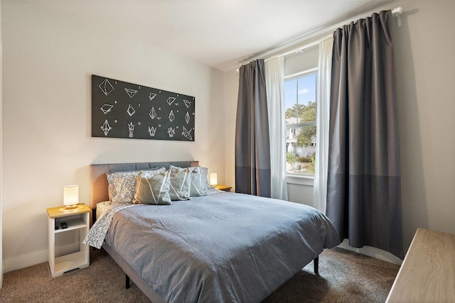 bedroom featuring carpet floors and baseboards