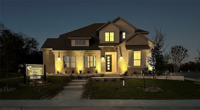 view of front of home featuring a lawn