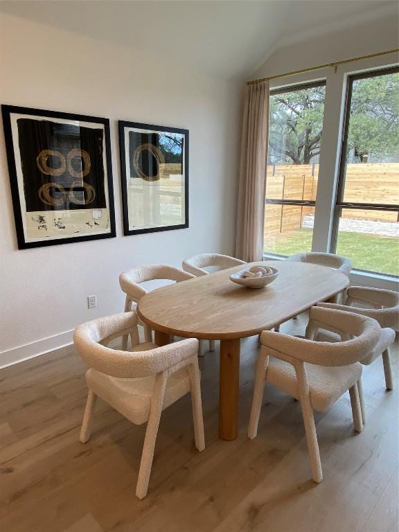 dining area with hardwood / wood-style flooring and lofted ceiling