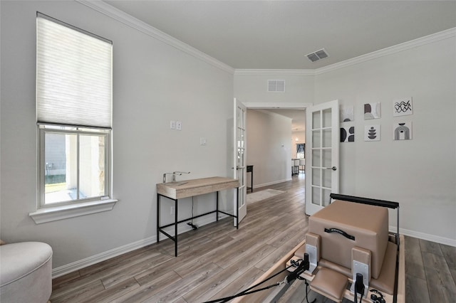 interior space featuring french doors, ornamental molding, and hardwood / wood-style floors