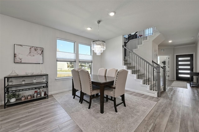 dining room with an inviting chandelier and light hardwood / wood-style floors