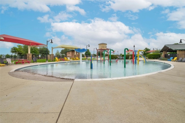 view of swimming pool with a playground