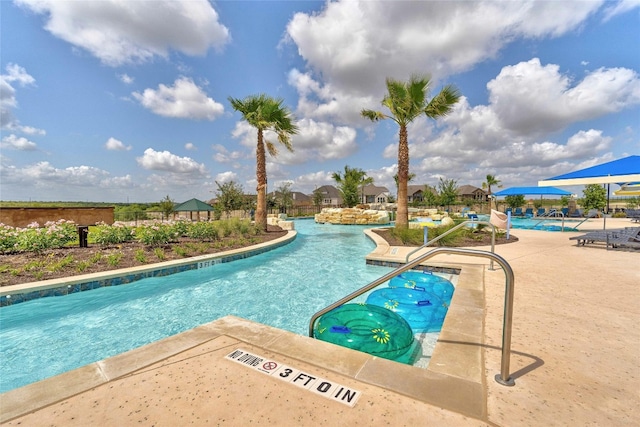 view of swimming pool with a patio area