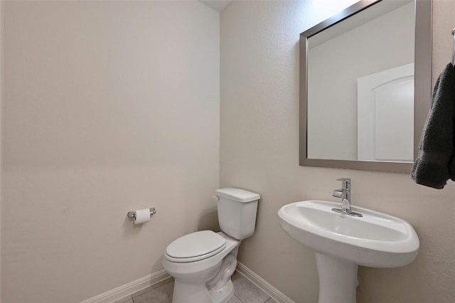 bathroom with sink, tile patterned floors, and toilet