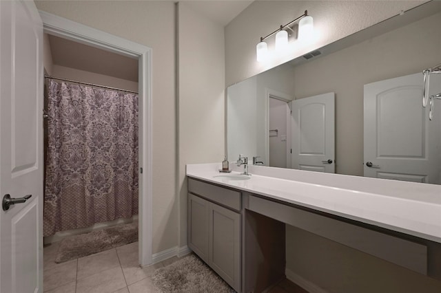 bathroom with tile patterned floors and vanity