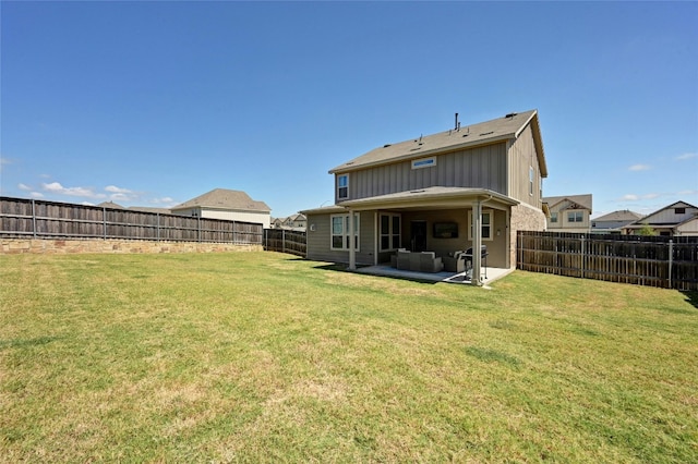 back of house with a yard and a patio area