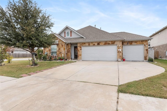 view of front of property featuring a garage and a front yard