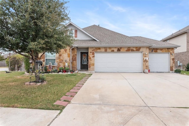 view of front of home with a front yard and a garage