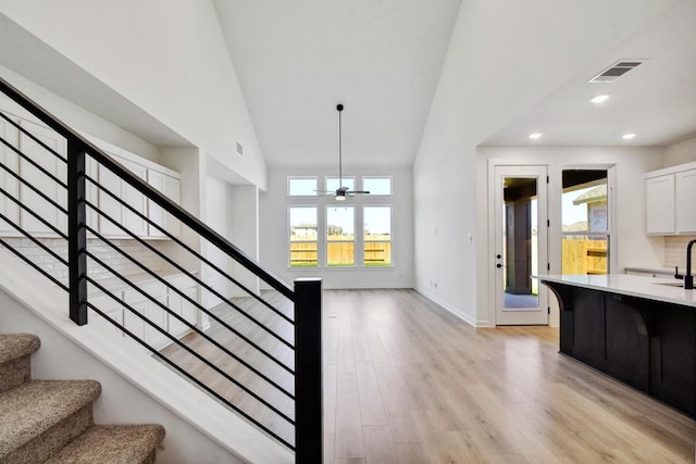 596 Biscayne Bay Bnd, Kyle, TX 78640 - staircase featuring visible vents, a ceiling fan, high vaulted ceiling, and a healthy amount of sunlight