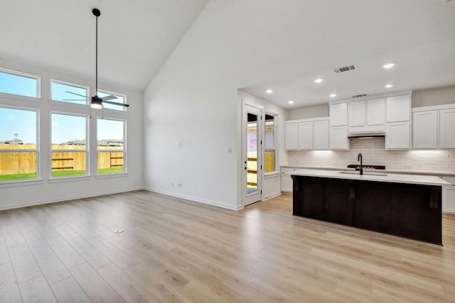 596 Biscayne Bay Bnd, Kyle, TX 78640 - kitchen featuring light countertops, backsplash, visible vents, and high vaulted ceiling