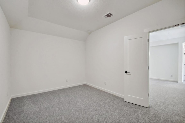 596 Biscayne Bay Bnd, Kyle, TX 78640 - carpeted empty room with lofted ceiling, baseboards, and visible vents