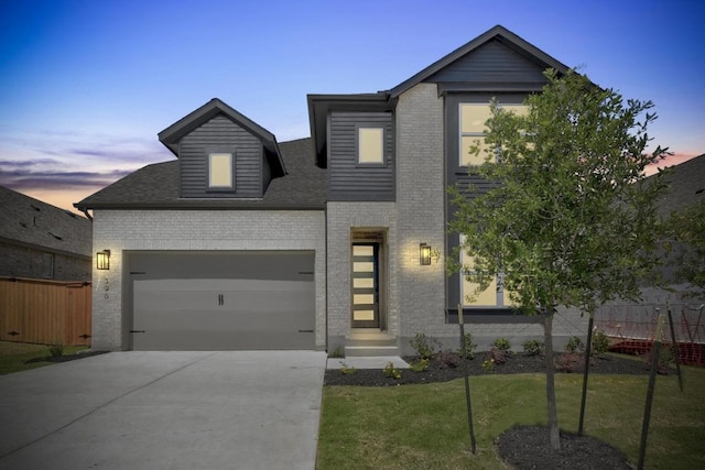 596 Biscayne Bay Bnd, Kyle, TX 78640 - modern home featuring concrete driveway, fence, a front yard, a garage, and brick siding