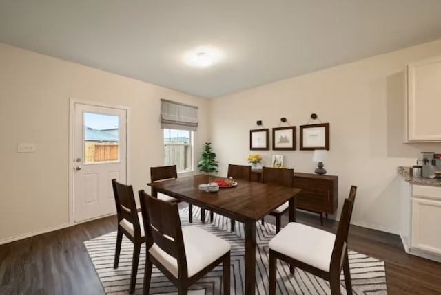 dining space with dark hardwood / wood-style floors