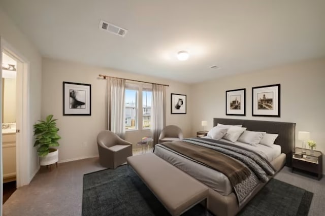 bedroom featuring connected bathroom and dark carpet