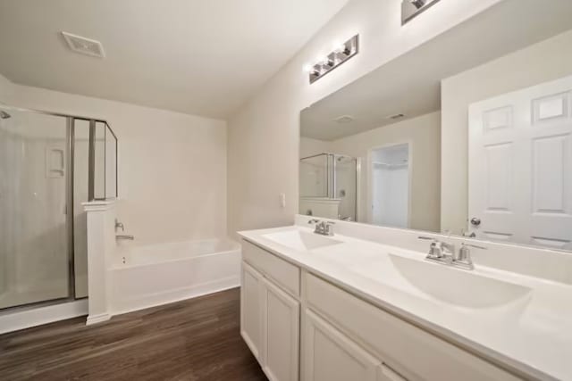 bathroom featuring vanity, independent shower and bath, and hardwood / wood-style flooring