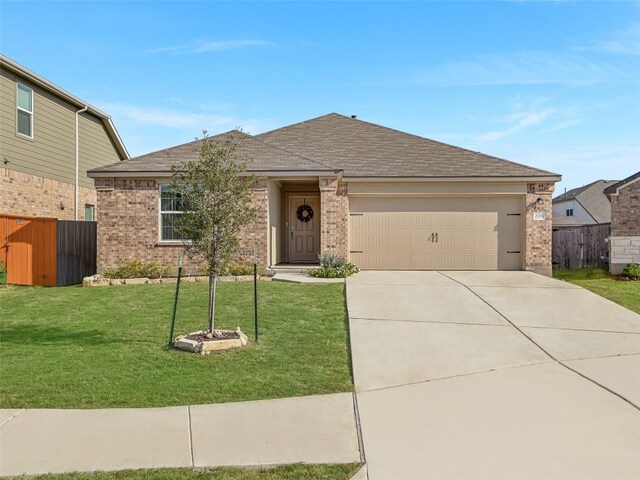 view of front of house with a garage and a front yard