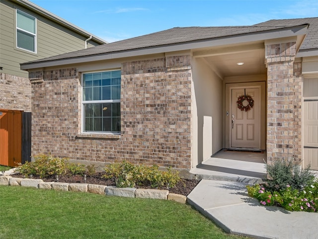 doorway to property with a lawn