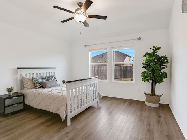 bedroom with ceiling fan and wood-type flooring