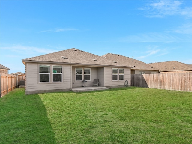 rear view of property featuring a lawn and a patio