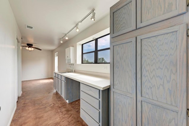 kitchen featuring gray cabinetry, ceiling fan, sink, and track lighting