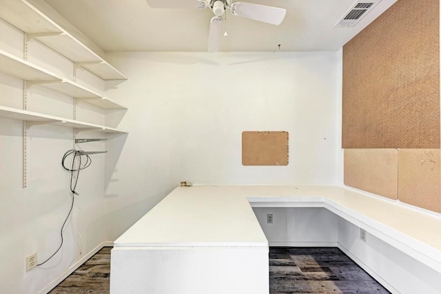 laundry area featuring ceiling fan and dark wood-type flooring