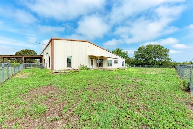 back of property featuring a yard