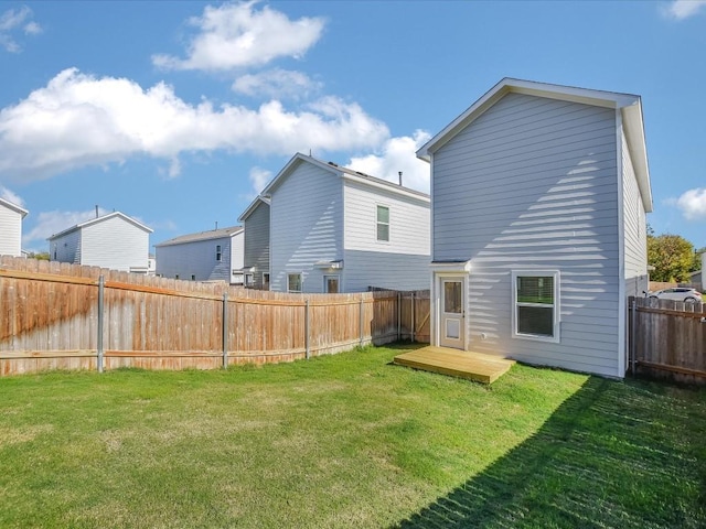 rear view of house featuring a yard