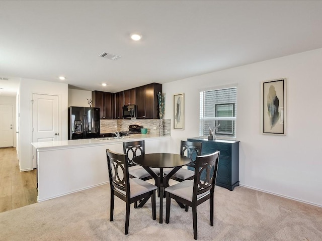 dining room with light hardwood / wood-style flooring and sink