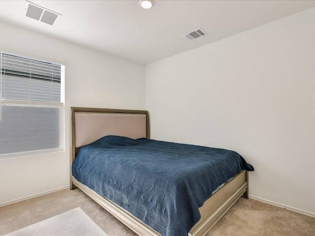 bedroom featuring light carpet