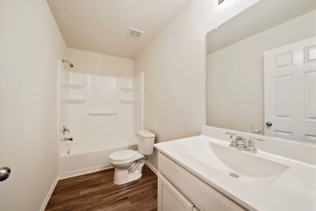 full bathroom featuring shower / washtub combination, vanity, wood-type flooring, and toilet