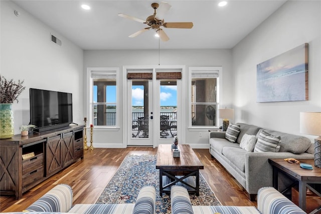 living room with ceiling fan, french doors, and dark wood-type flooring