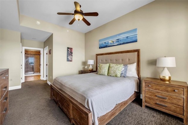 carpeted bedroom with ensuite bath and ceiling fan