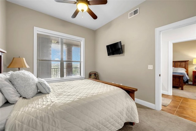 bedroom featuring ceiling fan and light carpet