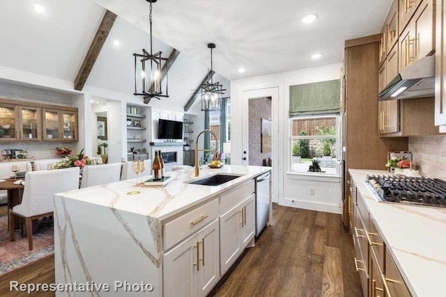 kitchen featuring a kitchen island with sink, dark wood-type flooring, sink, vaulted ceiling with beams, and tasteful backsplash